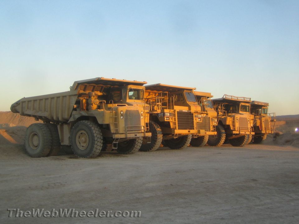 Row of yellow mining dump trucks