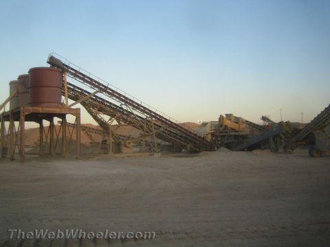 1968 Ford Mustang - Industrial scene a complex conveyor belt system at a mining or processing site.