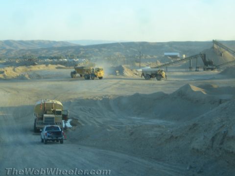 1968 Ford Mustang - Heavy equipment operates at a dusty mining site under a clear sky.