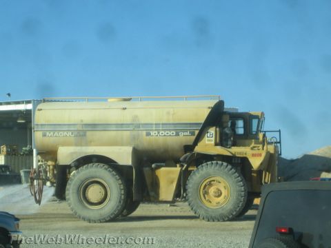 1968 Ford Mustang - Side view of a large yellow water truck with a 10,000 gallon capacity tank.