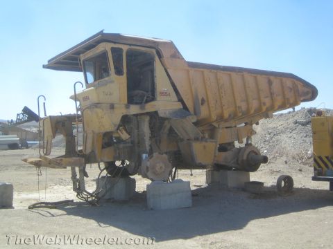 1968 Ford Mustang - This large dump truck, marked with 8554, is elevated on concrete blocks and appears to be undergoing maintenance or is decommissioned.