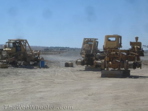 1968 Ford Mustang - Multiple chassis of heavy construction equipment are parked in an outdoor lot.