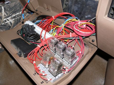 1988 Ford Bronco - A complex wiring harness with multiple relays is visible inside the vehicle's cabin.