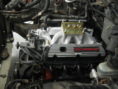 1988 Mercury Grand Marquis - Engine bay view showing a Ford V8 with performance modifications, including a Holley carburetor and Ford Motorsport valve covers.
