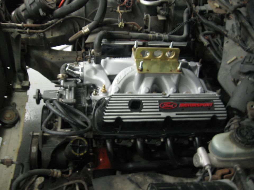 Close-up of a Ford Motorsport engine with aftermarket intake and valve covers