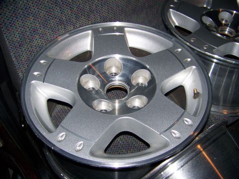 2001 Dodge 1500 - A close-up view of a silver 5-spoke rim, likely for a truck or SUV.