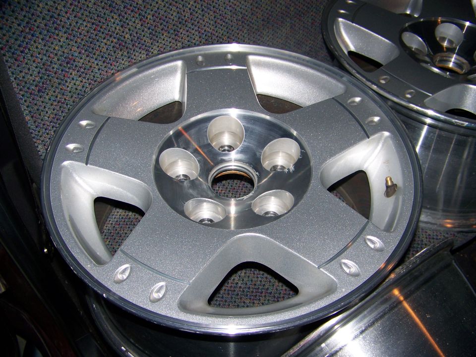 Silver 5-spoke rim with five lug nut holes