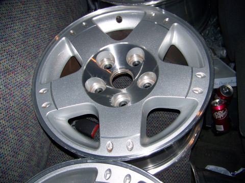 2001 Dodge 1500 - A single silver 5-spoke alloy wheel is shown, with two cans of Dr. Pepper in the background.