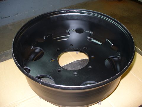 1978 Ford Bronco - A single black steel wheel is shown, likely for a truck or SUV, with visible welding marks on the hub.