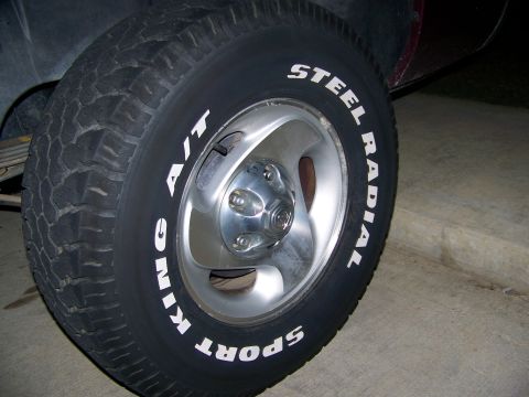 2001 Dodge 1500 - Close-up of a tire and rim with white lettering, showing tread detail and lug nuts.