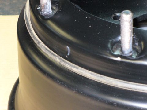 1978 Ford Bronco - Close-up view of a black wheel rim with visible studs and a distinct ring detail.
