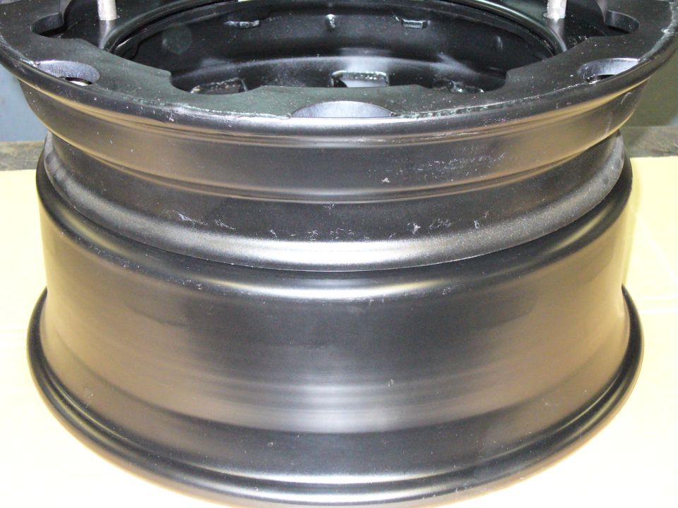 Black steel wheel rim with visible mounting holes and stepped lip