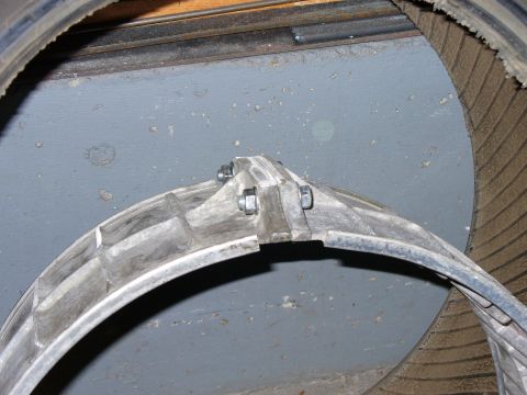 1978 Ford Bronco - Close-up of a wheel rim and tire assembly, with visible bolts securing the rim.