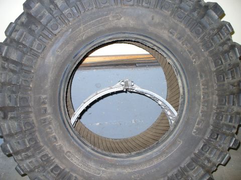 1978 Ford Bronco - A close-up view of an off-road tire reveals a beadlock ring installed within its rim.