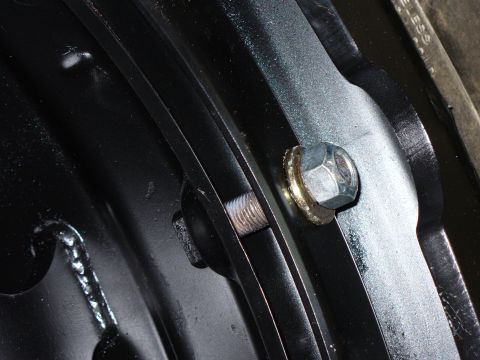 1978 Ford Bronco - A close-up view shows a lug nut and washer on a black metal component, with text visible in the lower right corner.