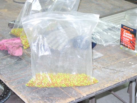 1978 Ford Bronco - Several plastic bags containing small, colorful balls are on a table, next to a jar of camouflage ammo.
