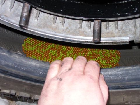 1978 Ford Bronco - Balancing beads are being added to the inside of a tire.