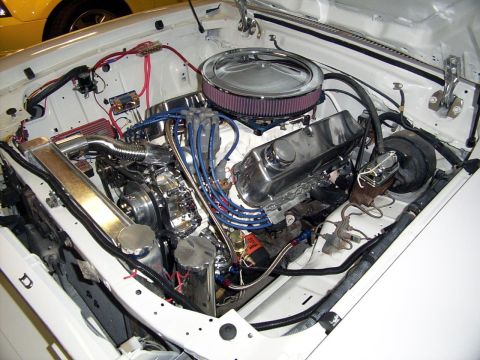 1978 Ford Mustang II - Custom V8 engine in a white vehicle's engine bay, with a glimpse of another car in the background.