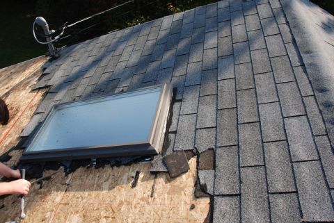 1996 Ford Bronco - Roof shingles are being replaced around a skylight during a repair job.