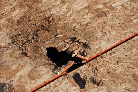 1996 Ford Bronco - The image shows damaged roof sheathing with a hole and orange tape, indicating a need for repair.