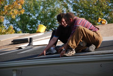 1996 Ford Bronco - Two men are working on a roof, with a yellow bucket and tool visible in the background.