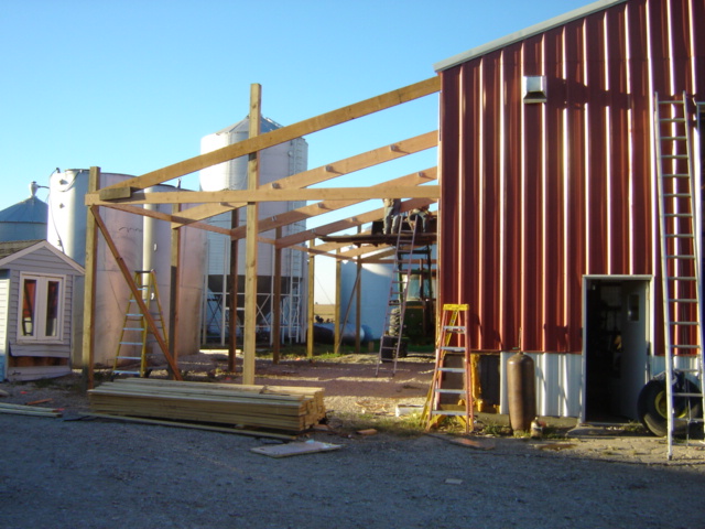 building under construction with silos in background