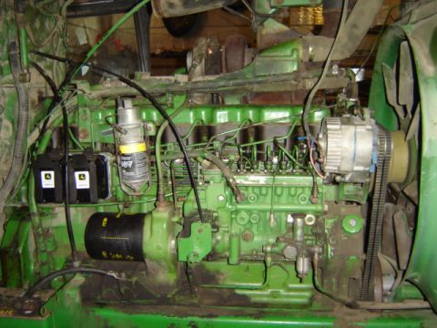 1992 Ford Bronco - Close-up view of a green tractor engine, showing various components and mechanical details.