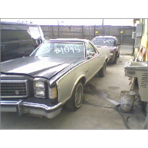 1973 Ford Ranchero - Two cars are parked in a junkyard, one with #1095 written on its windshield.
