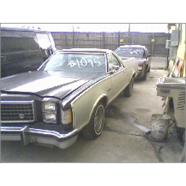 1977 Ford Ranchero and another car in a junkyard. #1095 written on windshield