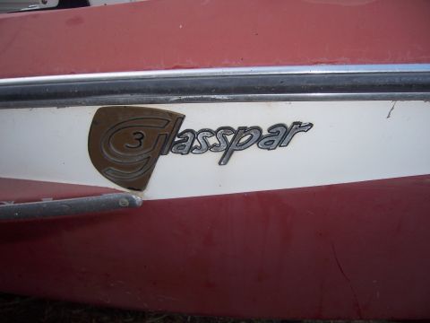 1991 Ford Bronco - A close-up view of a boat's side shows the "Glasspar 3" emblem against a red and white background.