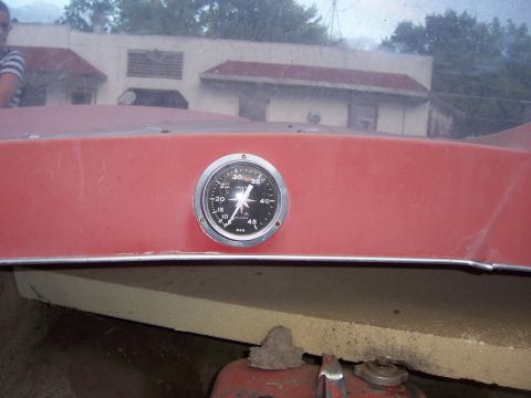 1991 Ford Bronco - A close-up of a boat's interior shows a speedometer and part of the engine below.