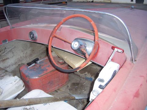 1991 Ford Bronco - Interior view of a boat, a steering wheel, throttle, and fuel tank.