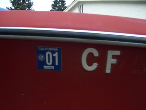 1991 Ford Bronco - A red boat displays a California registration sticker and the letters 'CF'.