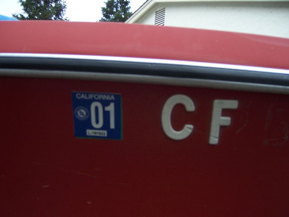 Red boat side with California registration sticker '01' and white letters 'CF'
