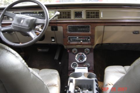 1989 Ford Crown Victoria LTD - The dashboard features wood grain trim, an aftermarket stereo, and several gauges below the radio.