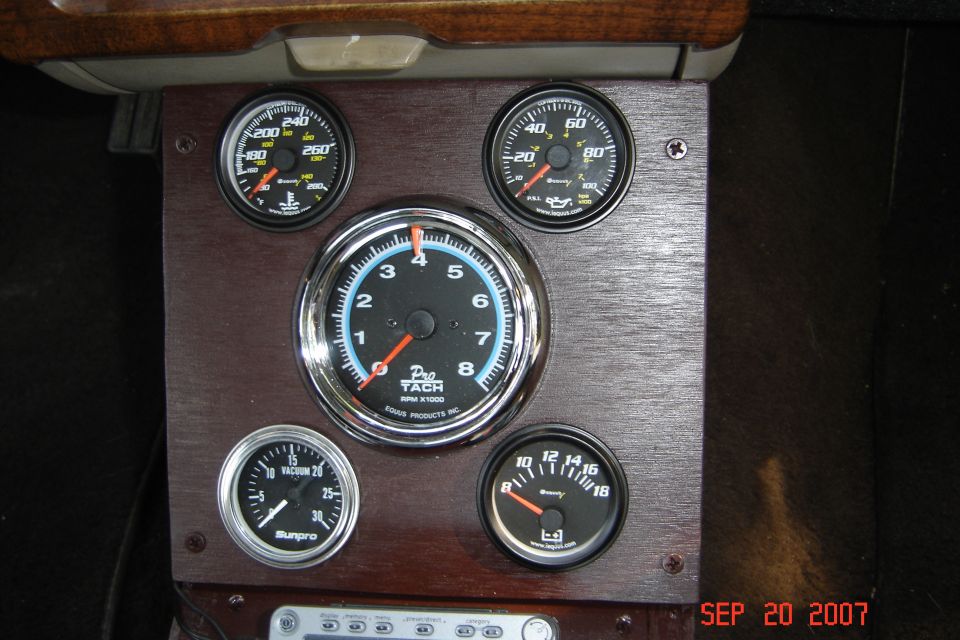 Dashboard with aftermarket gauges including a tachometer, oil pressure, vacuum, and temperature gauges