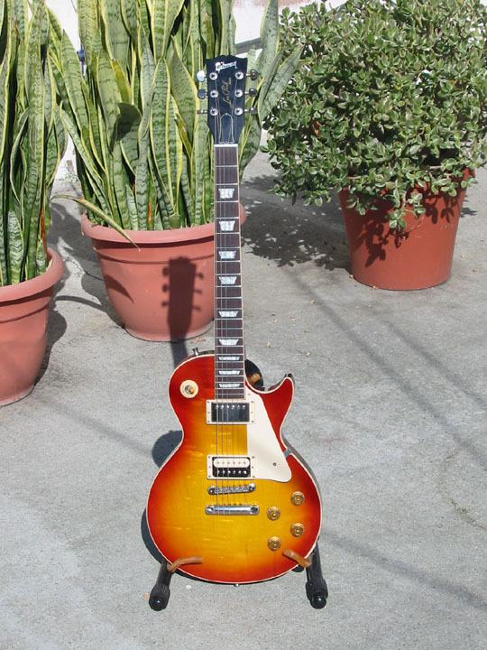 Sunburst electric guitar on stand