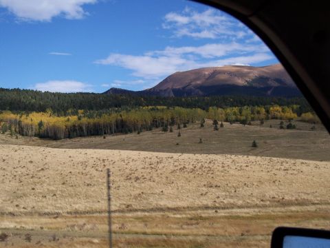 1972 Ford Ranchero - A scenic view of a mountain range and colorful autumn trees, seen through the window of a vehicle.
