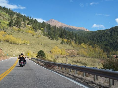 1972 Ford Ranchero - A motorcycle travels along a scenic mountain road during autumn.