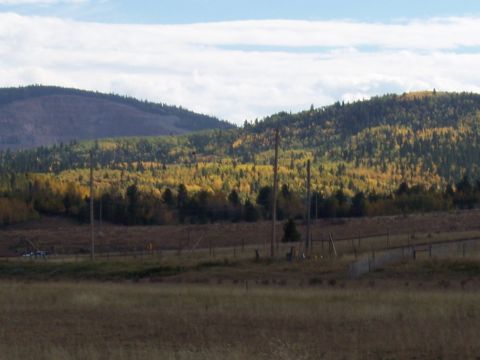 1972 Ford Ranchero - A scenic view of hills covered in autumn foliage, with power lines and a fence in the foreground.