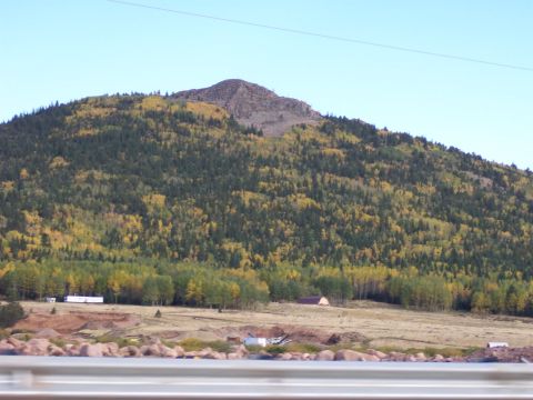 1972 Ford Ranchero - Mountain landscape with autumn trees and buildings under a clear blue sky.