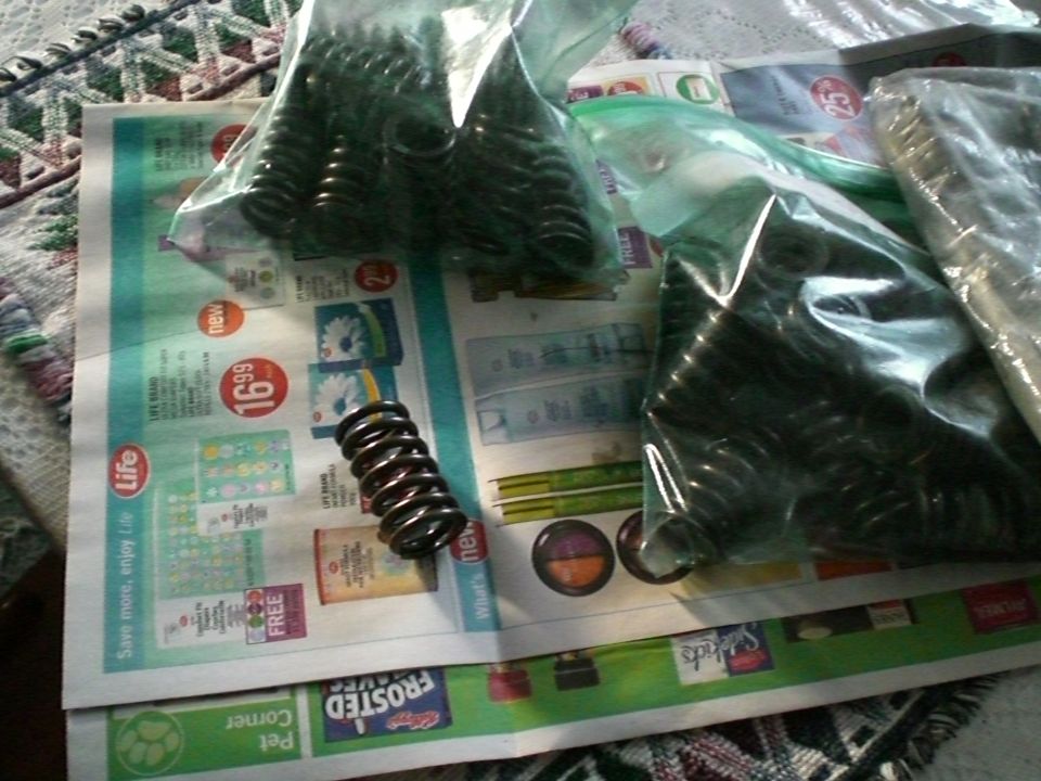 Set of coil valve springs in plastic bags on newspaper ads