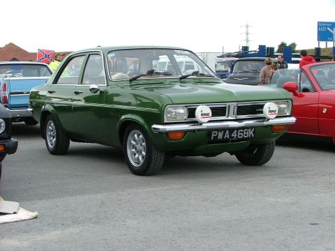 2001 Ford Fiesta - A green sedan with auxiliary lights and aftermarket wheels is parked outdoors.
