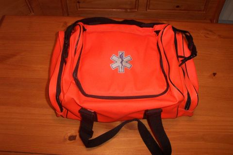1998 Ford Crown Victoria - An orange medical bag with a Star of Life symbol sits on a wooden surface.