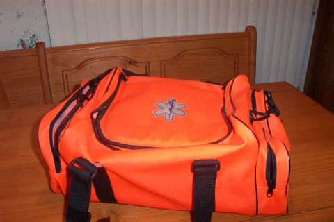 1998 Ford Crown Victoria - An orange medical bag with the Star of Life emblem sits on a wooden table.