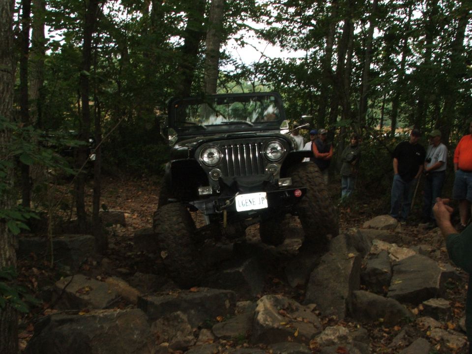 Black Jeep Wrangler navigating rocky terrain