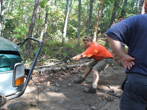 1996 Ford Bronco - People winching a 1996 Ford Bronco out of a wooded area.