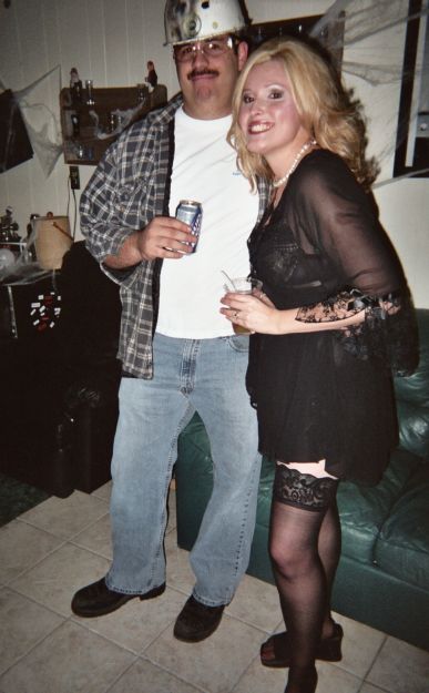 1991 Ford Bronco - A couple dressed in costumes pose for a photo indoors.
