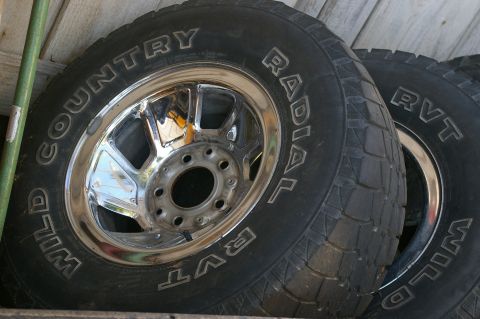 1986 Ford Bronco - Close-up of multiple Wild Country Radial RVT tires with chrome wheels.