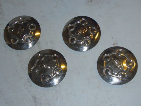 2000 Ford Crown Victoria - Set of four chrome Ford hubcaps, each the Ford oval logo and a five-lug pattern.